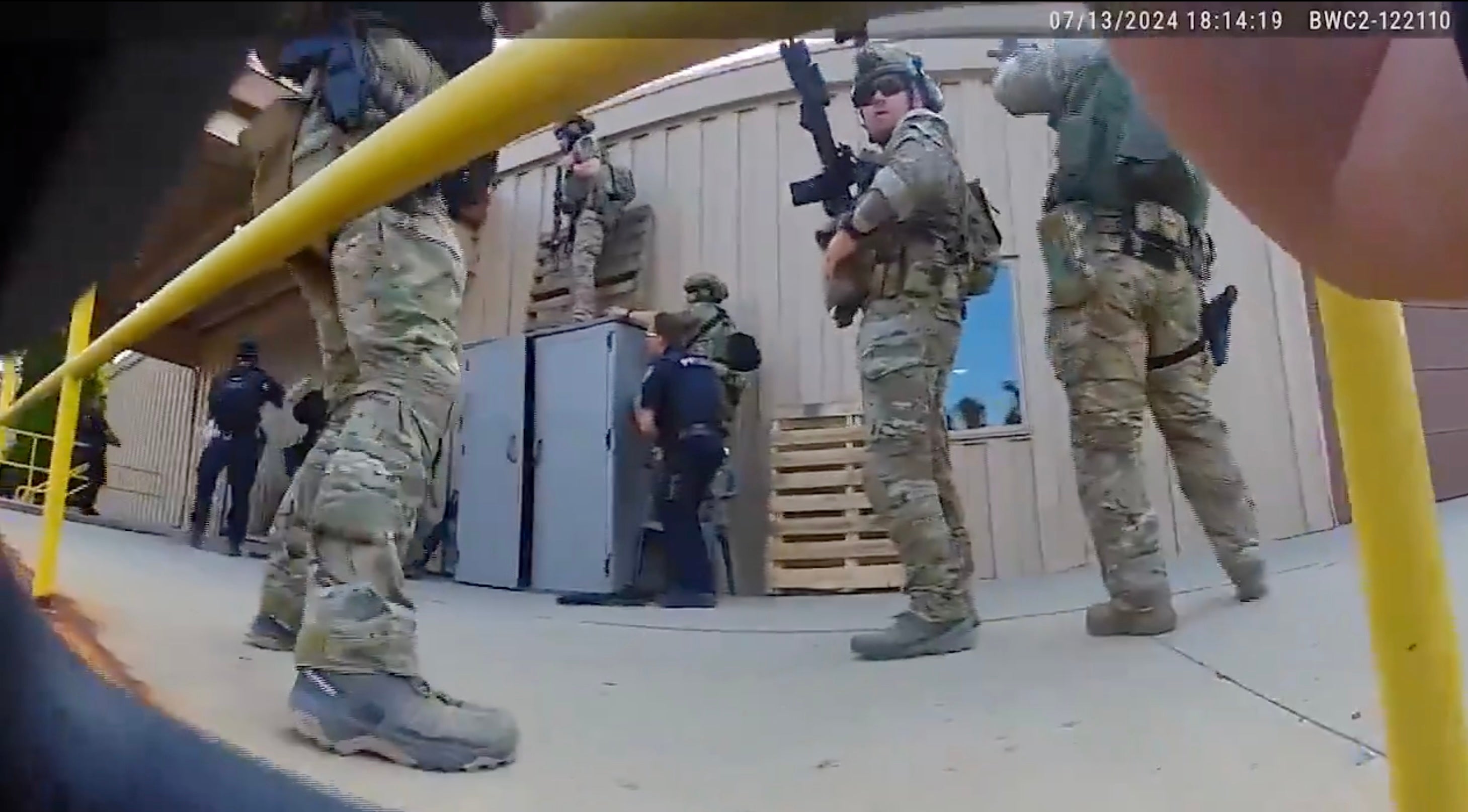 Still from body cam footage shows police getting ready to climb onto the roof after Crooks opened fire on Trump